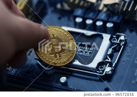 Bitcoin over computer motherboard, top view Bitcoin over computer motherboard, top view 96572838
