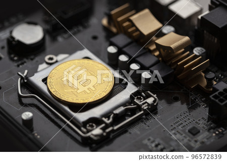 Bitcoin over computer motherboard, top view. Bitcoin over computer motherboard, top view. 96572839