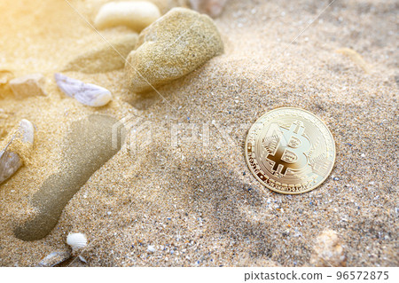 Bitcoin on the beach sand with shells and stones. Single golden BTC crypto coin banner in warm tones with copy space top view. Environment impact of mining cryptocurrency concept. Bitcoin on the beach sand with shells and stones. Single golden BTC crypto coin banner in warm tones with copy space top view. Environment impact of mining cryptocurrency concept. 96572875