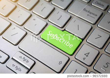Green Subscribe button on laptop keyboard close-up. Green Subscribe button on laptop keyboard close-up. 96572880