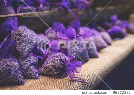 Lavender bud dry flower sachet fragrant bags, purple organza pouch with natural dried lavender flowers at market. Toned image with selective soft focus and copy space. 96572882