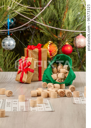 Wooden lotto barrels with bag and game cards for a game in lotto. 96573325