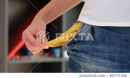 Woman turning inside and showing empty jeans pocket 96575106