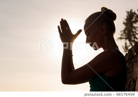 beautiful woman meditating outdoors 96576499