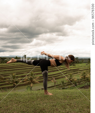 girl doing yoga outdoors 96576500