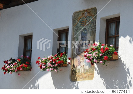 Austria, Innsbruck suburb, Mutters village, flowers by the window Austria, Innsbruck suburb, Mutters village, flowers by the window 96577414