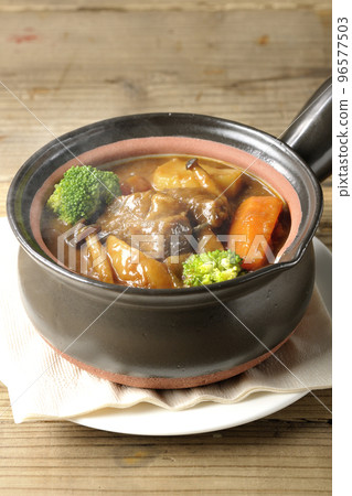 Hot beef stew with lots of ingredients such as broccoli, carrots, and shimeji mushrooms in a pot 96577503