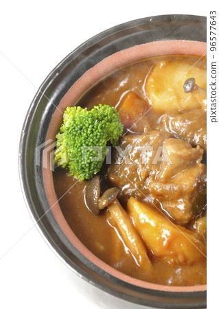 A bird's-eye view of a hot beef stew with many ingredients such as broccoli, carrots, and shimeji mushrooms in a pot with a white background 96577643