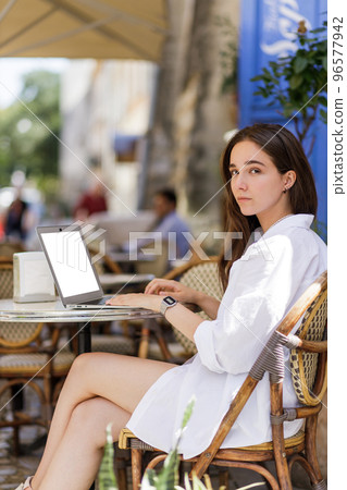 Online education concept mock up image of young attractive girl using laptop with blank screen 96577942