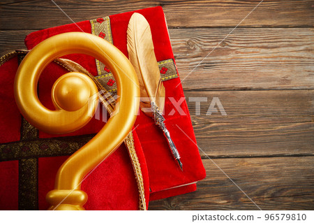6th december Saint Nicholas Day - Sinterklaas. St Nicholas mitre and book on wooen table 6th december Saint Nicholas Day - Sinterklaas. St Nicholas mitre and book on wooen table 96579810