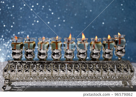 Jewish holiday Hanukkah background with menorah -traditional candelabra and oil candles Jewish holiday Hanukkah background with menorah -traditional candelabra and oil candles 96579862