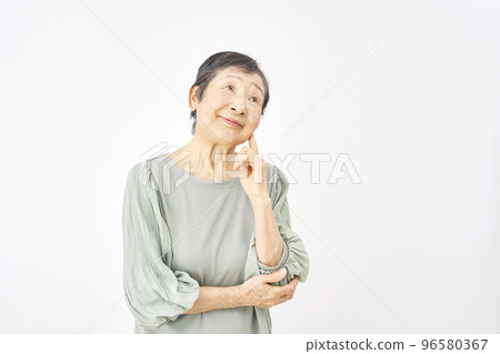 Thinking elderly woman white background 96580367