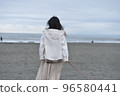 A woman walking in the winter sea 96580441