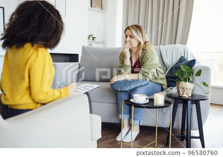 Female African American psychotherapist offering female middle age client Female African American psychotherapist offering female middle age client 96580760