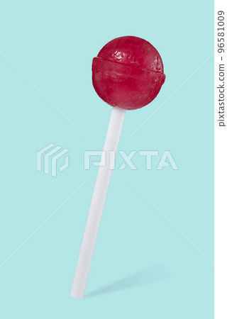 Close-up of a red lollipop in the shape of a ball on a stick, isolated on a beautiful turquoise background with a shadow. Sweets. Close-up of a red lollipop in the shape of a ball on a stick, isolated on a beautiful turquoise background with a shadow. Sweets. 96581009