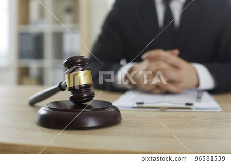 Judge's gavel on wooden office table of professional lawyer providing legal services 96581539