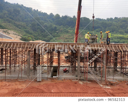 MELAKA, MALAYSIA - MARCH 4, 2021: The building structure is made of reinforced concrete still under construction. This reinforced concrete mold is made of timber and plywood formwork. 96582313