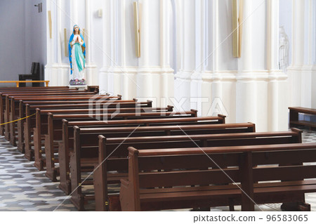People pray in the church. Church parish. Believers sit on benches in the hall. People pray in the church. Church parish. Believers sit on benches in the hall. 96583065