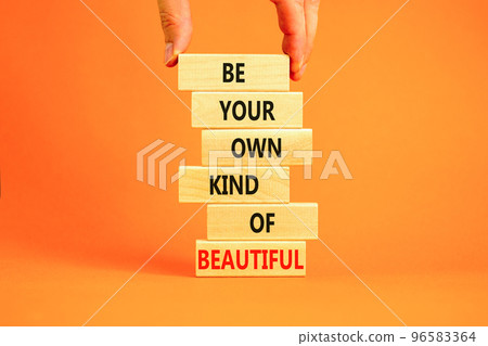 Be beautiful symbol. Concept words Be your own kind of beautiful on wooden blocks on a beautiful orange table orange background. Businessman hand. Business be your own kind of beautiful concept. 96583364