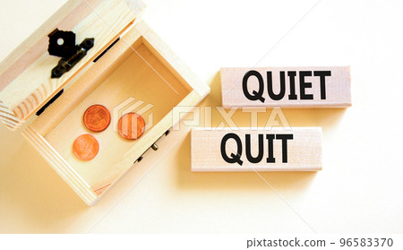 Quiet quit symbol. Concept words Quiet quit on wooden blocks. Beautiful white table white background. Wooden chest with coins. Business and quiet quit concept. Copy space. 96583370