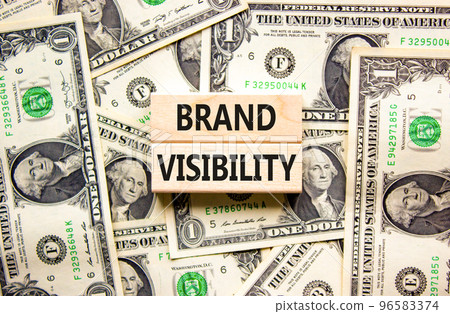 Brand visibility symbol. Concept words Brand visibility on wooden blocks. Beautiful background from dollar bills. Business branding and brand visibility concept. Copy space. Brand visibility symbol. Concept words Brand visibility on wooden blocks. Beautiful background from dollar bills. Business branding and brand visibility concept. Copy space. 96583374