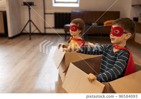 Superhero children. Super hero kids, brother and sister, playing at home Superhero children. Super hero kids, brother and sister, playing at home 96584093