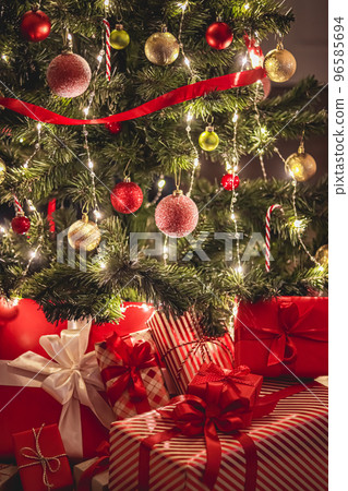 Christmas gifts and festive holiday presents, classic xmas gift boxes under decorated christmas tree, happy holidays and boxing day celebration theme 96585694