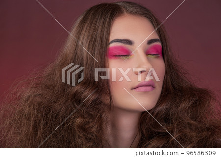 Close-up portrait, girl with long curly hair and red shades for eyes 96586309