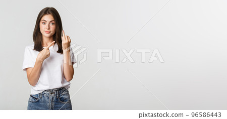 Displeased brunette girl complaining to boyfriend, pointing at finger without wedding ring 96586443