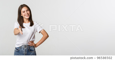 Smiling confident young woman extend hand for handshake, greeting person 96586502