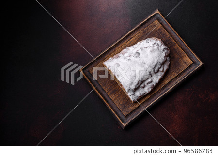 Christmas pie stollen with marzipan, berries and nuts on a dark concrete background Christmas pie stollen with marzipan, berries and nuts on a dark concrete background 96586783