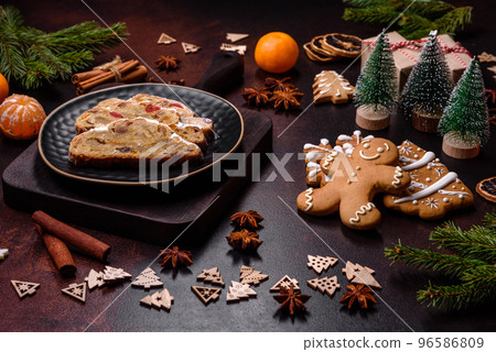 Christmas pie stollen with marzipan, berries and nuts on a dark concrete background 96586809