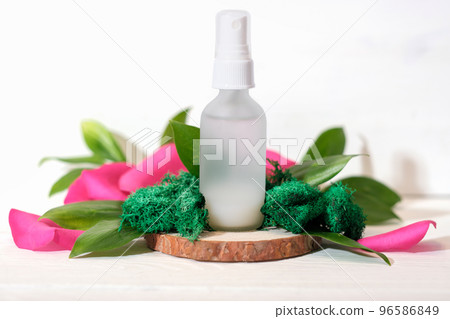 Mock up glass spray bottle on wooden saw cut podium with rose petals and moss and leaves. beauty fermented cosmetic skin care product, Mock up glass spray bottle on wooden saw cut podium with rose petals and moss and leaves. beauty fermented cosmetic skin care product, 96586849