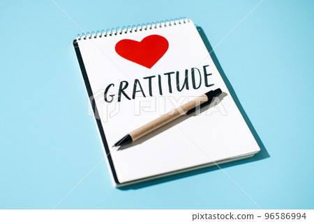 How to Practice Gratitude. Word Gratitude in open notebook on table. Notice appreciate good things, Express gratitude to yourself. Word Gratitude and red heart in open notebook on blue background How to Practice Gratitude. Word Gratitude in open notebook on table. Notice appreciate good things, Express gratitude to yourself. Word Gratitude and red heart in open notebook on blue background 96586994