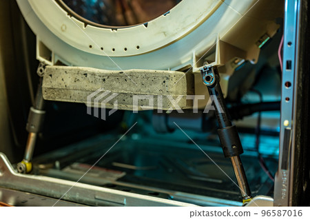 Selective Focus on the gasket mount of a front loading washing machine being serviced 96587016