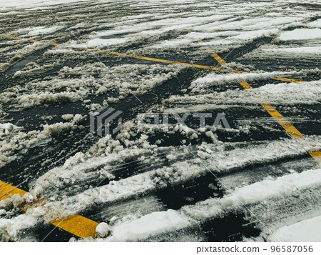 view of a parking lot after a snow storm with crisscrossing lines view of a parking lot after a snow storm with crisscrossing lines 96587056