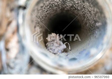 Interior view of dryer vent line with lint and dust buildup Interior view of dryer vent line with lint and dust buildup 96587060