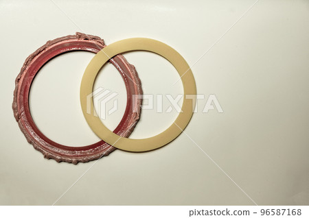 Old and new seal gasket from the flapper mechanism of a leaky residential bathroom toilet 96587168