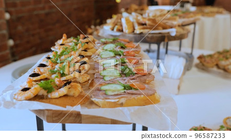 Catering. Table in a restaurant with appetizers at an event. Wedding buffet with fish and meat appetizers. Buffet with cold appetizers. Breakfast buffet at the hotel 96587233