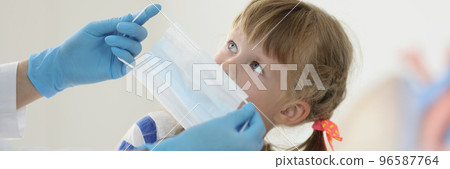 Doctor put face mask on kid face to protect from virus spread Doctor put face mask on kid face to protect from virus spread 96587764