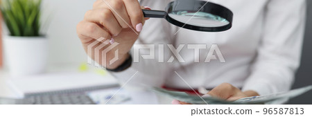 Female hold magnifying glass analyzing business financial data, manager calculates company finances Female hold magnifying glass analyzing business financial data, manager calculates company finances 96587813