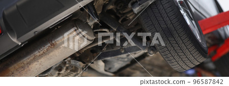 Car lifted in maintenance service for checkup, undercarriage of automobile, bottom view Car lifted in maintenance service for checkup, undercarriage of automobile, bottom view 96587842