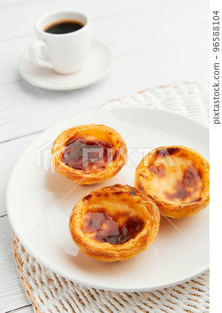 Traditional Portuguese egg tart dessert Pasteis Pastel de nata or Pasteis de Belem with coffee over white background 96588104
