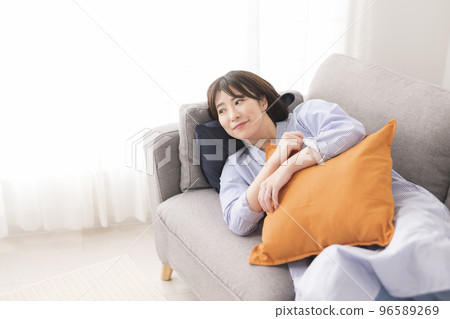 Woman relaxing in the living room 96589269