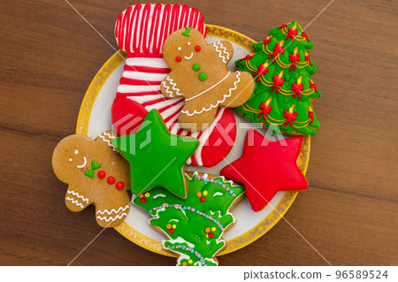 Plate with tasty Christmas cookies on wooden table Plate with tasty Christmas cookies on wooden table 96589524