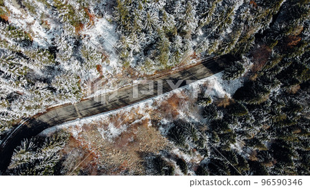 Aerial high angle view of narrow winding curvy mountain road. 96590346