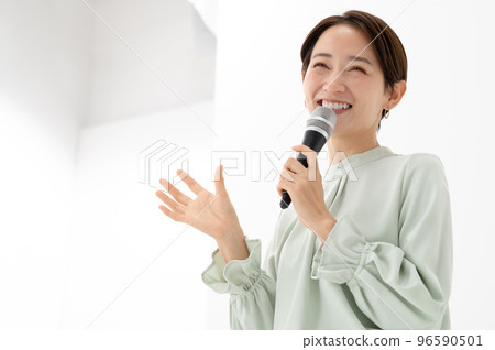 Woman holding a microphone White background 96590501