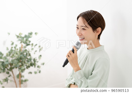 Woman holding a microphone White background 96590513