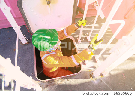 Offshore oil and gas industry and operated by technician petroleum. Worker walking to oil and gas plant for work as routine plan. Maintenance and Operation work scope in oil and gas plant. Offshore oil and gas industry and operated by technician petroleum. Worker walking to oil and gas plant for work as routine plan. Maintenance and Operation work scope in oil and gas plant. 96590660