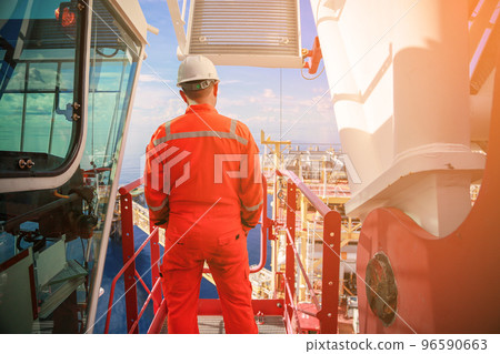 Offshore oil and gas industry and operated by technician petroleum. Worker walking to oil and gas plant for work as routine plan. Maintenance and Operation work scope in oil and gas plant. Offshore oil and gas industry and operated by technician petroleum. Worker walking to oil and gas plant for work as routine plan. Maintenance and Operation work scope in oil and gas plant. 96590663